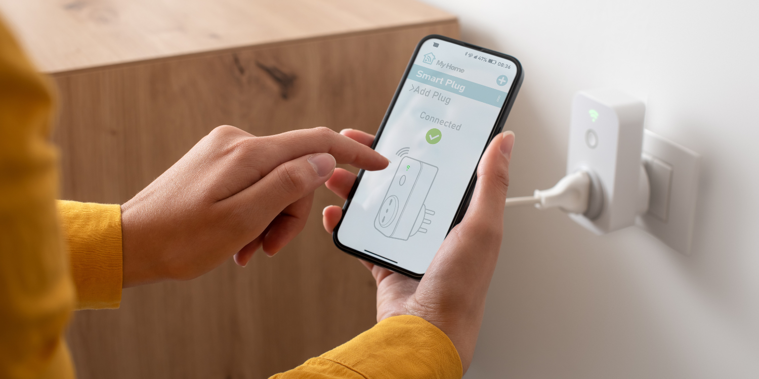 Women using smart phone on smart switch - Making Your Home Smarter