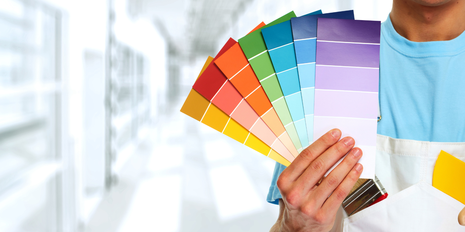 Painter holding colour samples - How to Choose a Painting Company That Fits Your Needs