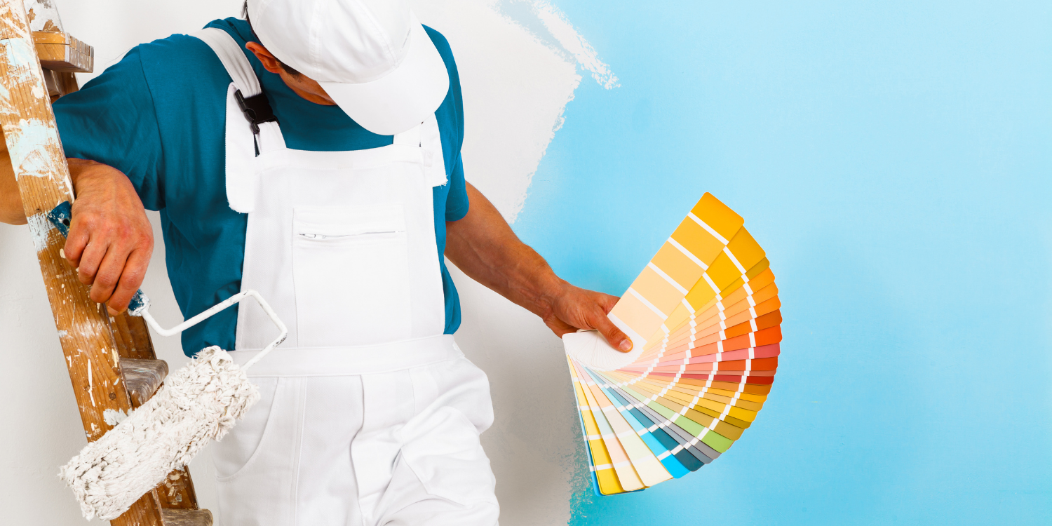 Painter looking at samples - 5 Questions to Ask Your Cabinet Painter Before They Start