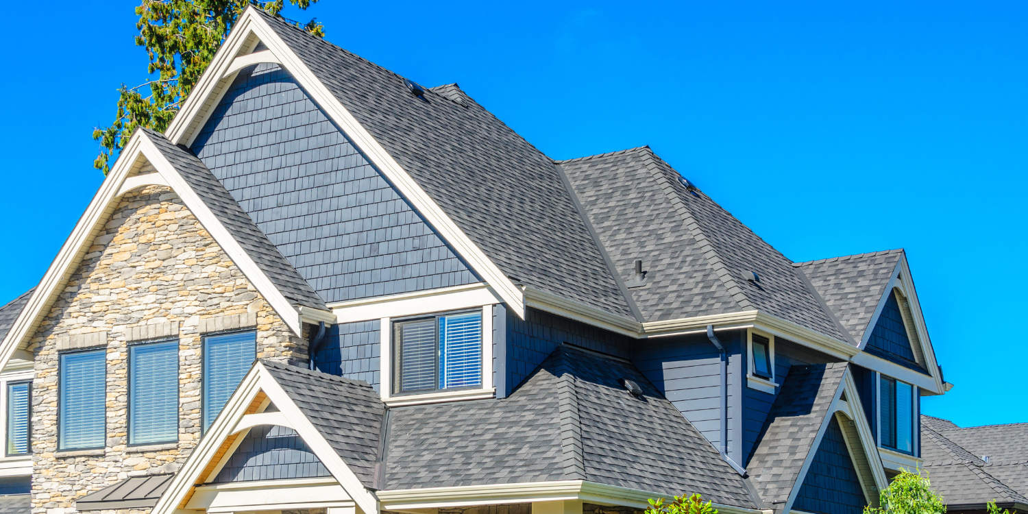 Grey roof on large home - Protecting Your Roof Before and After a Storm